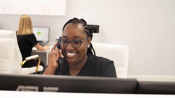 Dental assistant helping a customer on the phone