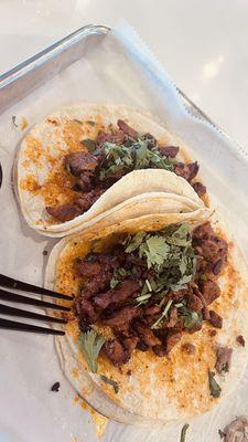 Tacos al pastor, the orange on the tortilla is the "adobo", it is not cheddar cheese.