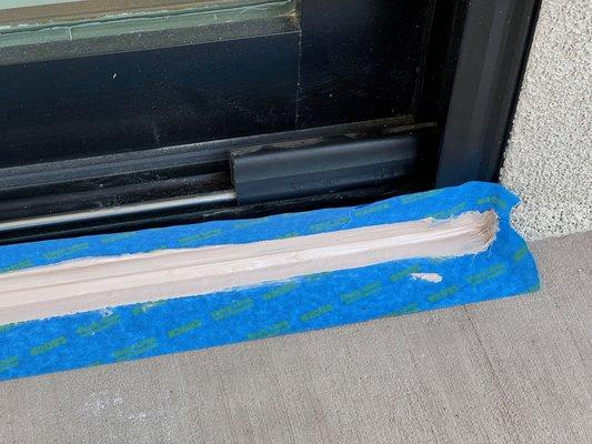 Expired Sikaflex sealant used to caulk under sliding doors.