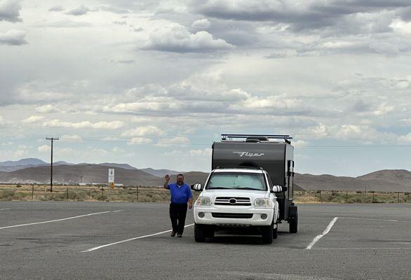 My husband, our car and the trailer at a rest stop.