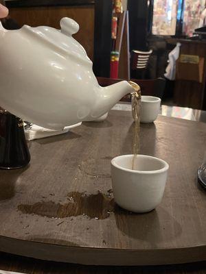 Pouring a cup of hot tea.