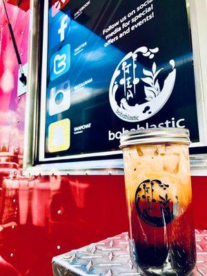 Iced Thia Tea in a glass jar with metal straw