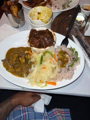 Pick 2 curry goat with Oxtails,rice and peas with cabbage