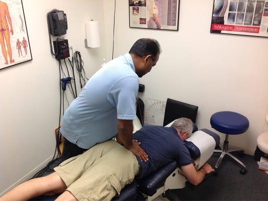 Dr Dilo treating my fiancé for lower back pain.