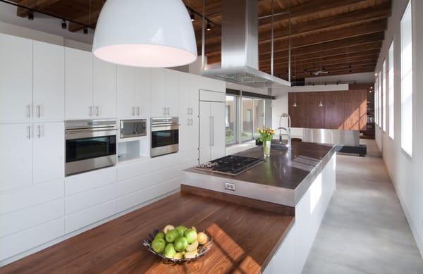 Contemporary kitchen in Chicago. Stainless steel Island top. Walnut dining top. This project has a large WOW factor!