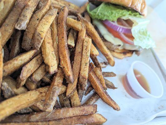 Grilled chicken sandwich with fries.