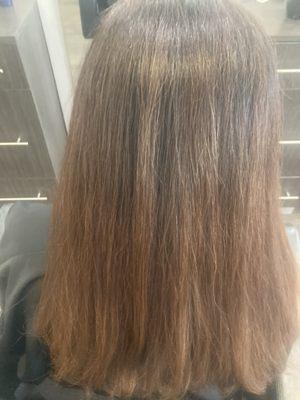 Straighten out wavy hair to see thorough color service.