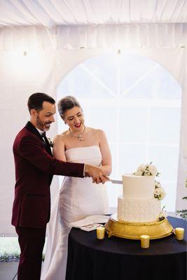 A couple cuts a wedding cake.