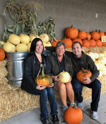 Heather, Karen, and Jacob are showing off our pumpkin display.