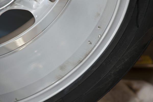 Damage that a tire shop did to my rims.