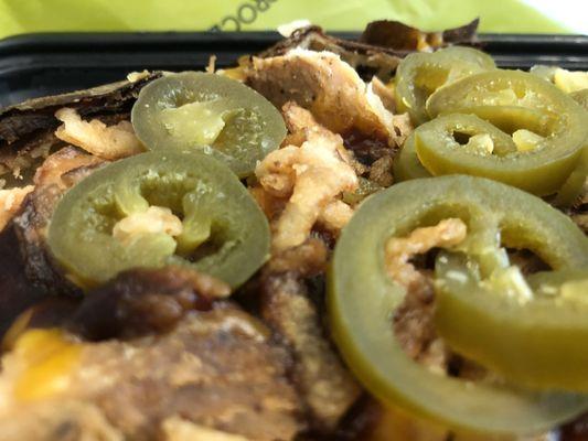 close up: BBQ Chicken Potato, chicken breast, butter, sour cream, cheddar, BBQ sauce, jalapenos, crispy onions