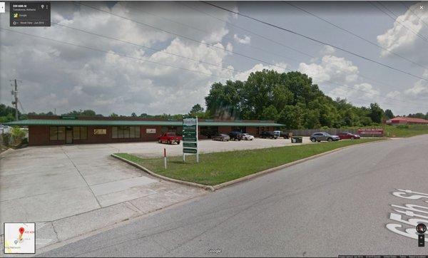 Office Building in front of storage buildings.