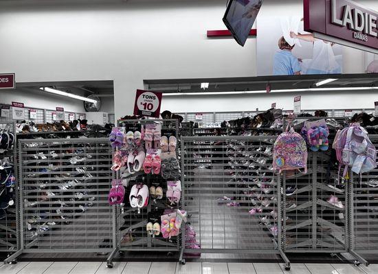 This is the gate surrounding the entire shoe department. A security officer blocks the entrance. It's like a makeshift prison.