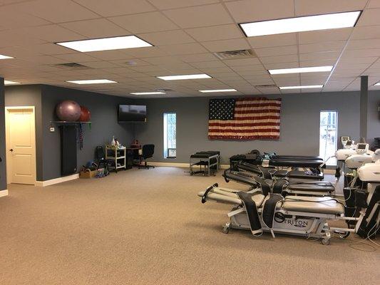 Physical rehab area with cervical and lumbar spinal decompression therapy, course debility exercise training, postural correction training.