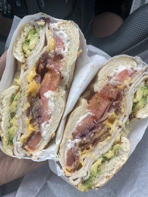 Onion bagel with cream cheese, bacon, cheddar, tomato, onion, avocado