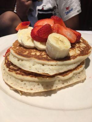 Double stack of pancakes with strawberries and bananas