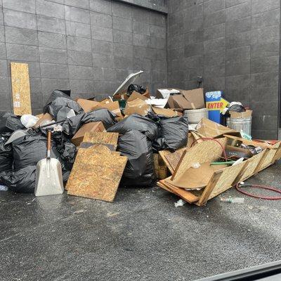 A close up photo of the garbage dump in the back. Something is very off about this car wash business.