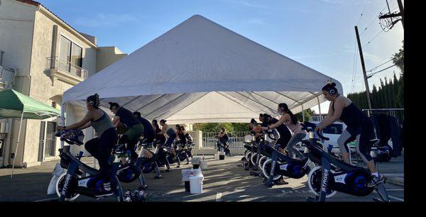 Outdoor cycling class under a large tent. Nice and shady!