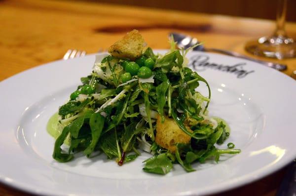 Arugula and frisee salad with English peas and champagne vinaigrette.