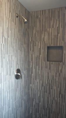 We created a visually interesting shower from an old drab "70's" look.