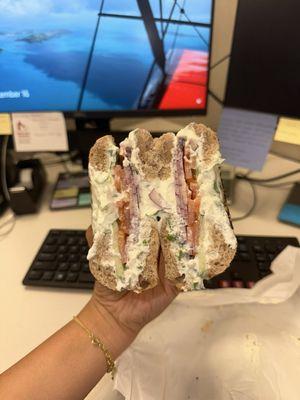 Tomato, cucumber, & onion with chive cream cheese on a wheat bagel