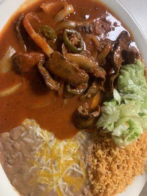 Steak Ranchero hold the bell peppers. Excellent. Love the red sauce.