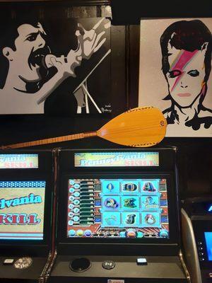 Freddie Mercury & David Bowie paintings above game machines at Dobbs On South