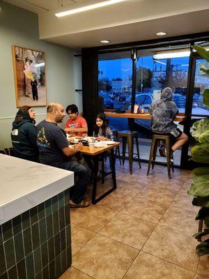 The dining area. One table for four and a counter with three seats.