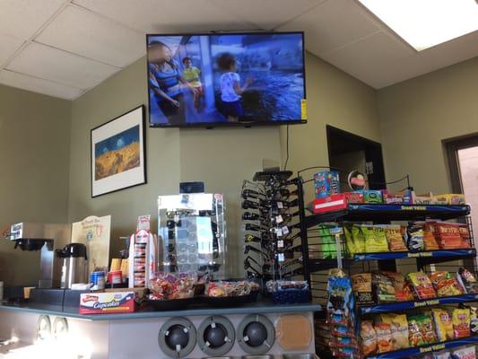 Comfy seats inside the store with nice TV