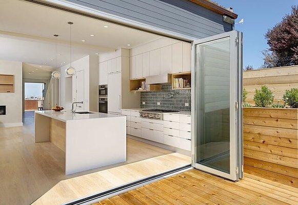 Bespoke kitchen finished in white satin conversion varnish, with solid White Oak details.