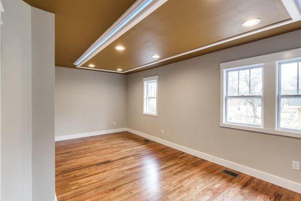 Master Bedroom Renovation with Drop down ceiling with led accent lighting, can lights, refinished original hardwood floors and new windows.