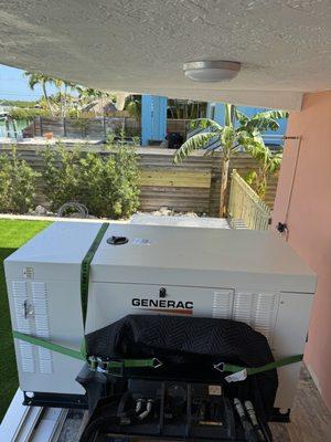 Dingo moving a 32kw Generac carefully into it's new home