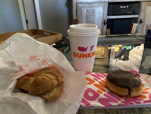 Coffee, Boston cream and a Sausage Egg and Cheese on a Croissant