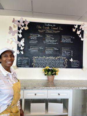 The owner next to her menu. Such a sweet soul.