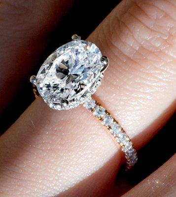 2 carat oval diamond solitaire with yellow gold diamond band.