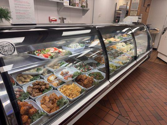 Deli cases overflowing with tasty dinners and salads.