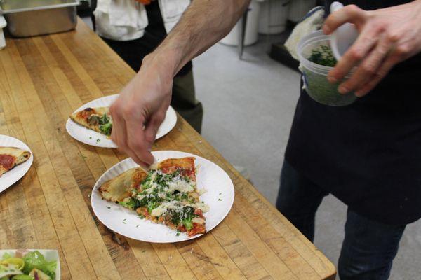 Chef Matthew putting the finishing touches on our broccoli sausage pizza.