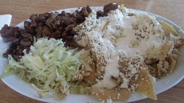 Chilaquiles verde with carne asada. Finger licking good!