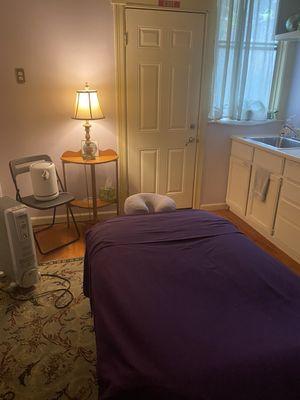 Massage room with electric massage table extra padding and easy to get on especially for disabled and elderly clients.