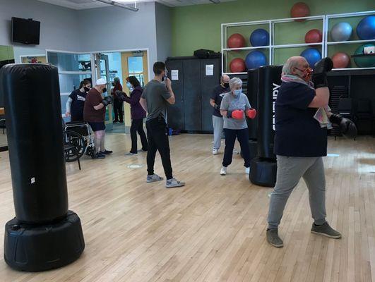 A Rock Steady Boxing program (open to the public) supports individuals with Parkinson's disease.