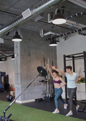 Form training this badass client on a landmine overhead press.