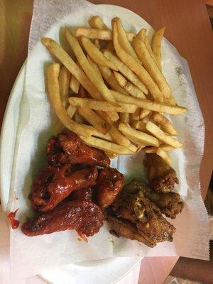 Extra hot wings, lemon pepper wings, and fries