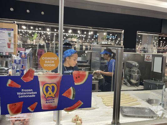 Employees hand-rolling, twisting, and baking the pretzels on the spot