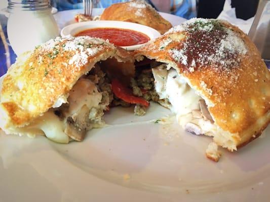 Calzone with sausage, ricotta, pepperoni, and mushrooms. Delicious!