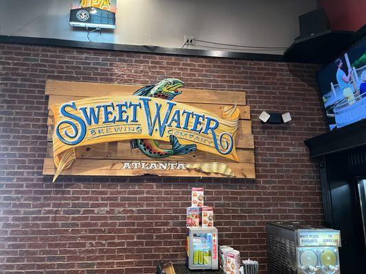 Sweet Water prominently featured on the wall near the bar area.