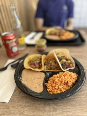 3 taco plates with rice and beans