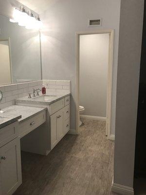 Lighting, Wood-like Tiles, Prefabricated white shaker vanity cabinets w/ vanity countertop and square undermount sink.