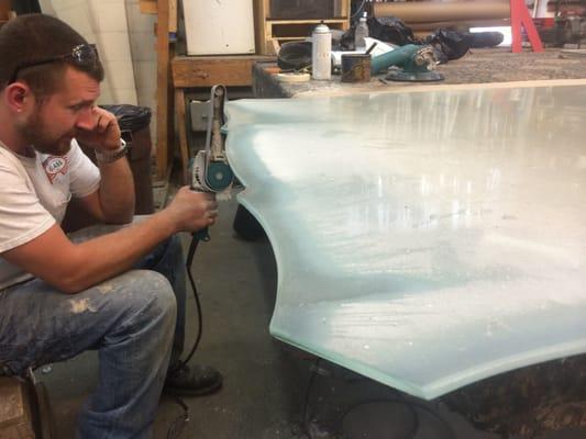 Kevin Jr. polishing the edges of a 1/4" Glass Patterned Tabletop.