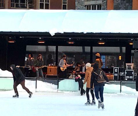 Band playing on the stage at the ice skating rink. Very cool.