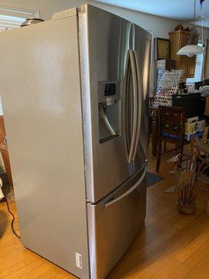 My old refrigerator that works but has been moved three times now .